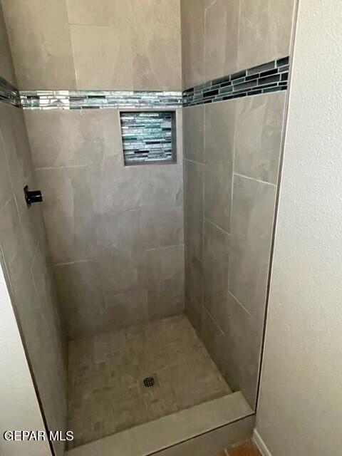 bathroom with a tile shower