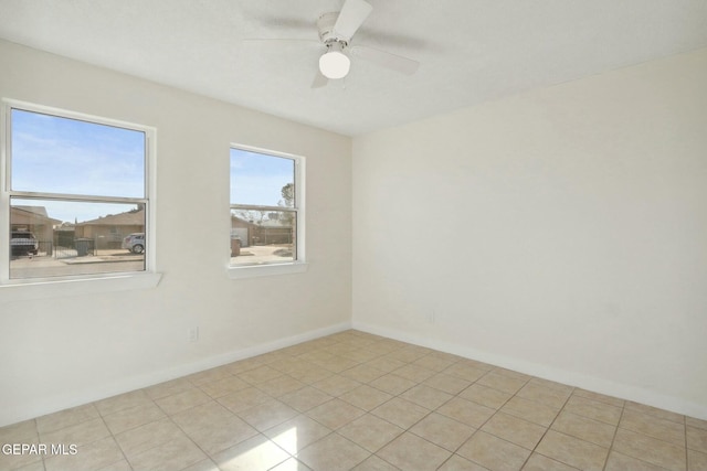 unfurnished room with ceiling fan and light tile patterned floors