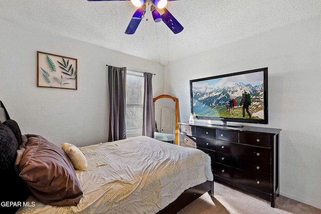 bedroom featuring light carpet, a textured ceiling, and ceiling fan