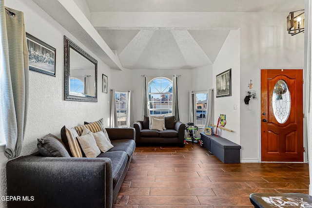 living room with a textured ceiling and lofted ceiling