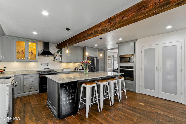 kitchen with wine cooler, black appliances, a center island, wall chimney exhaust hood, and beam ceiling