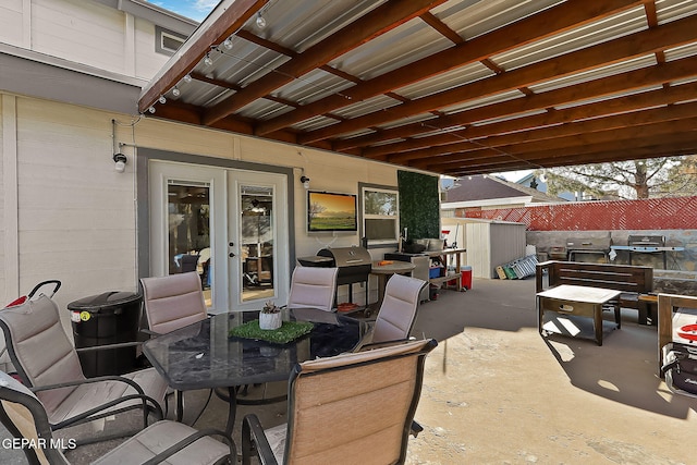 view of patio with area for grilling and a storage unit