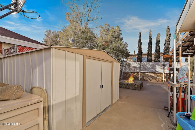 view of outbuilding with a fire pit