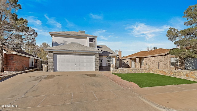 view of front of home featuring a front yard and a garage