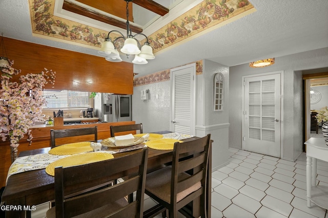 dining area with a notable chandelier and a textured ceiling