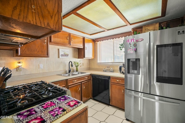 kitchen with sink, dishwasher, range with gas cooktop, custom exhaust hood, and stainless steel refrigerator with ice dispenser