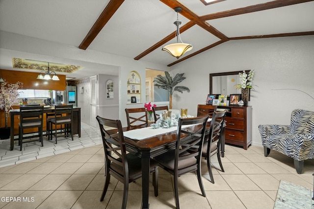 dining room featuring a notable chandelier, light tile patterned floors, and vaulted ceiling with beams