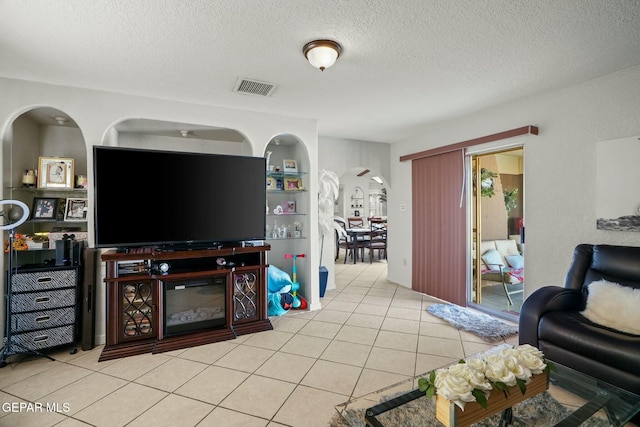 tiled living room with a textured ceiling