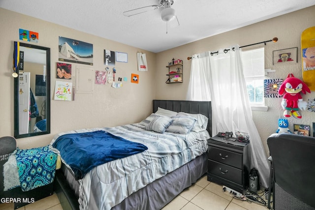 tiled bedroom featuring a textured ceiling and ceiling fan