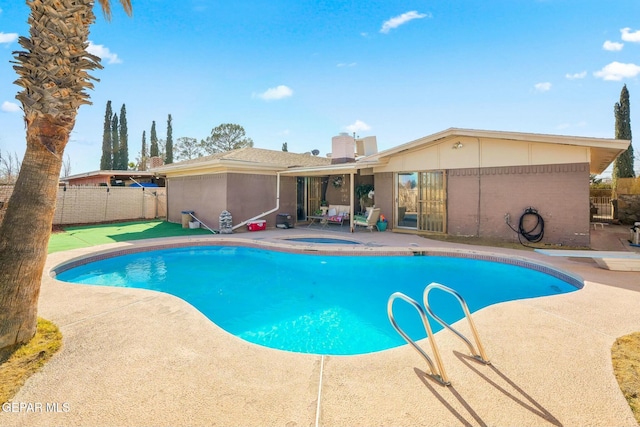 view of pool with a hot tub and a patio