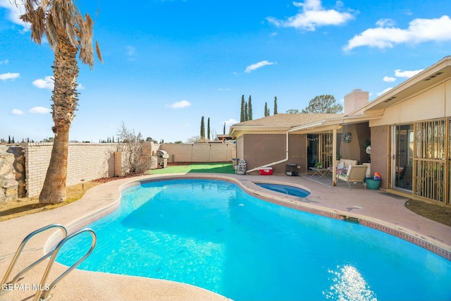 view of swimming pool featuring an in ground hot tub