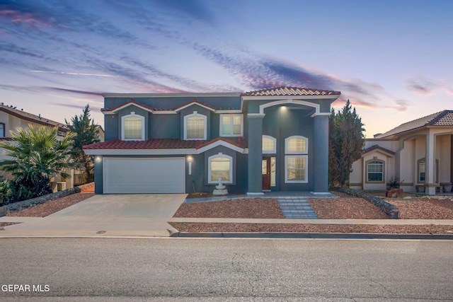 mediterranean / spanish house featuring a garage