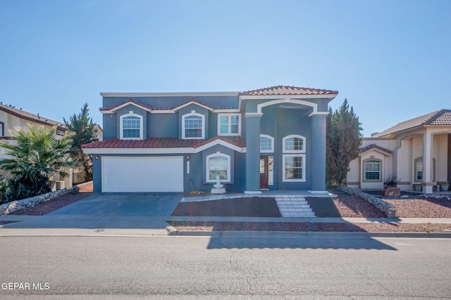 mediterranean / spanish-style home with a garage