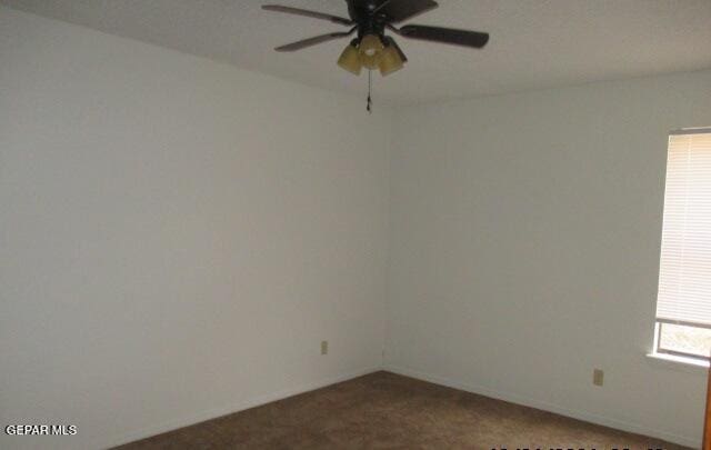 unfurnished room featuring ceiling fan and carpet floors