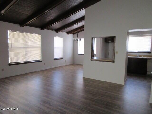 spare room with wood ceiling, dark hardwood / wood-style floors, and beamed ceiling