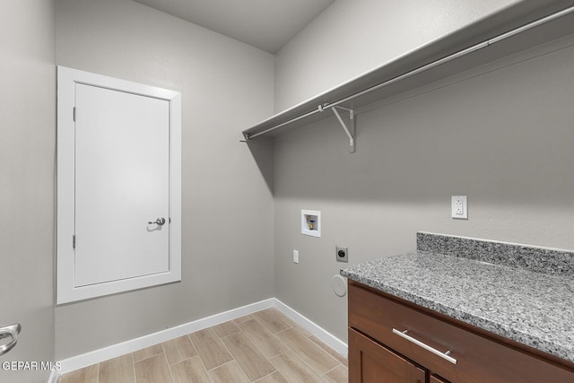 washroom with laundry area, baseboards, hookup for an electric dryer, wood finish floors, and washer hookup