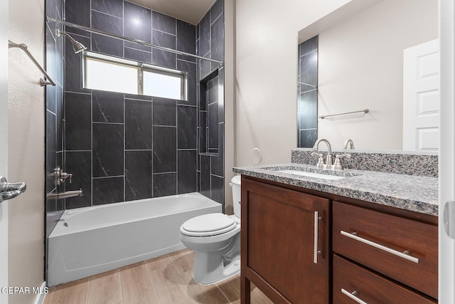 full bathroom with vanity, toilet, tiled shower / bath combo, and wood-type flooring