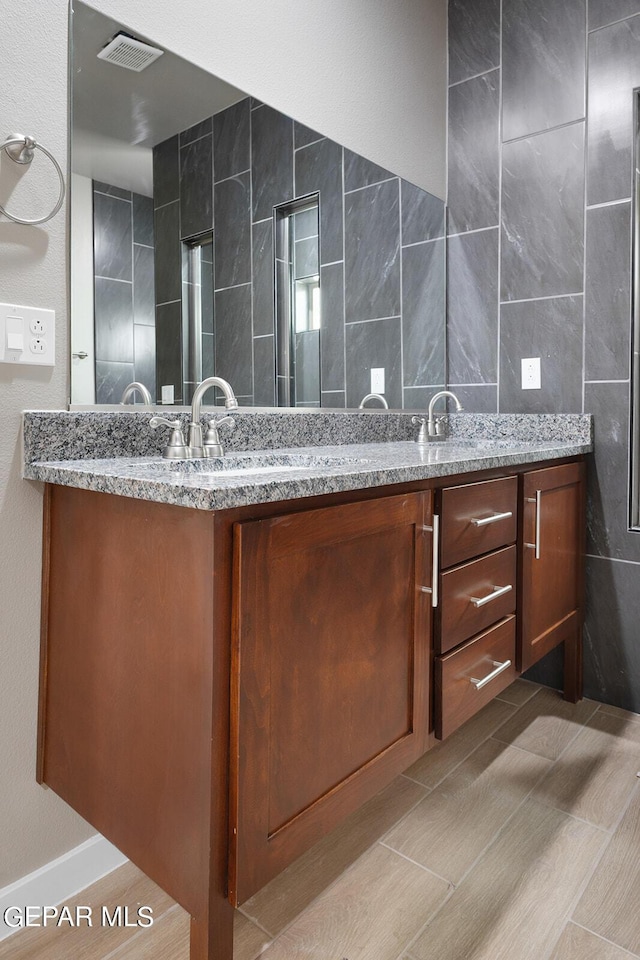 bathroom featuring tile walls and vanity