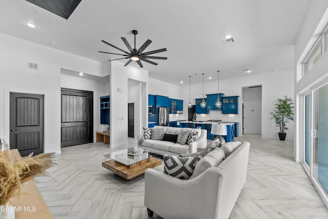 living room with light parquet floors and ceiling fan