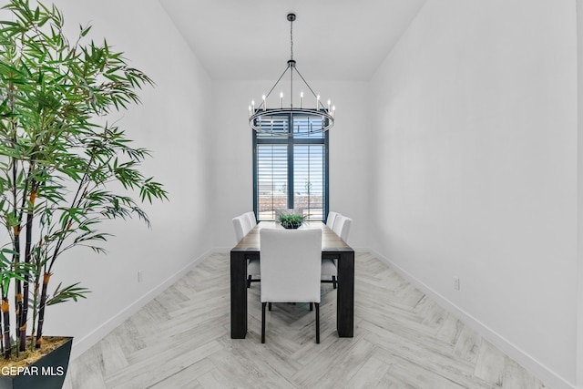 dining area with an inviting chandelier and light parquet flooring