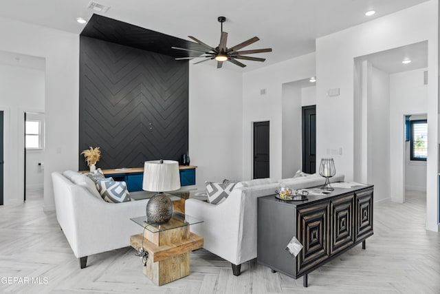 living room featuring light parquet flooring and ceiling fan