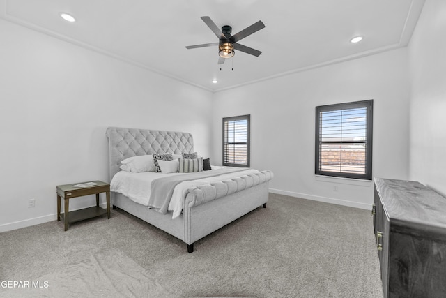 carpeted bedroom featuring ceiling fan, ornamental molding, and multiple windows