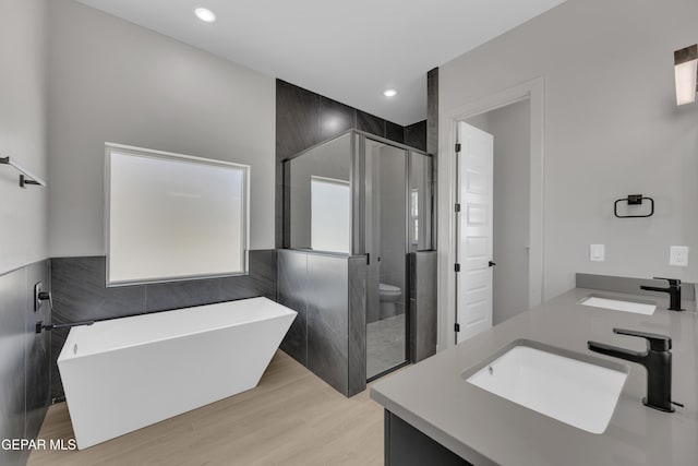 12869 Kingsbury Ave, Horizon City, TX 79928 - full bath with a stall shower, tile walls, a sink, and a freestanding tub