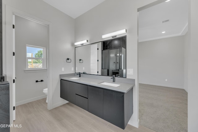 12869 Kingsbury Ave, Horizon City, TX 79928 - full bathroom with double vanity, toilet, baseboards, and a sink