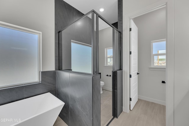 12869 Kingsbury Ave, Horizon City, TX 79928 - bathroom with recessed lighting, toilet, a stall shower, a freestanding bath, and baseboards