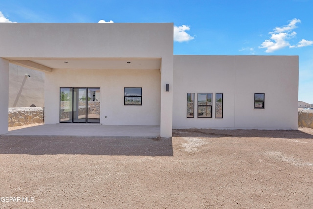 12869 Kingsbury Ave, Horizon City, TX 79928 - back of house featuring stucco siding and a patio area