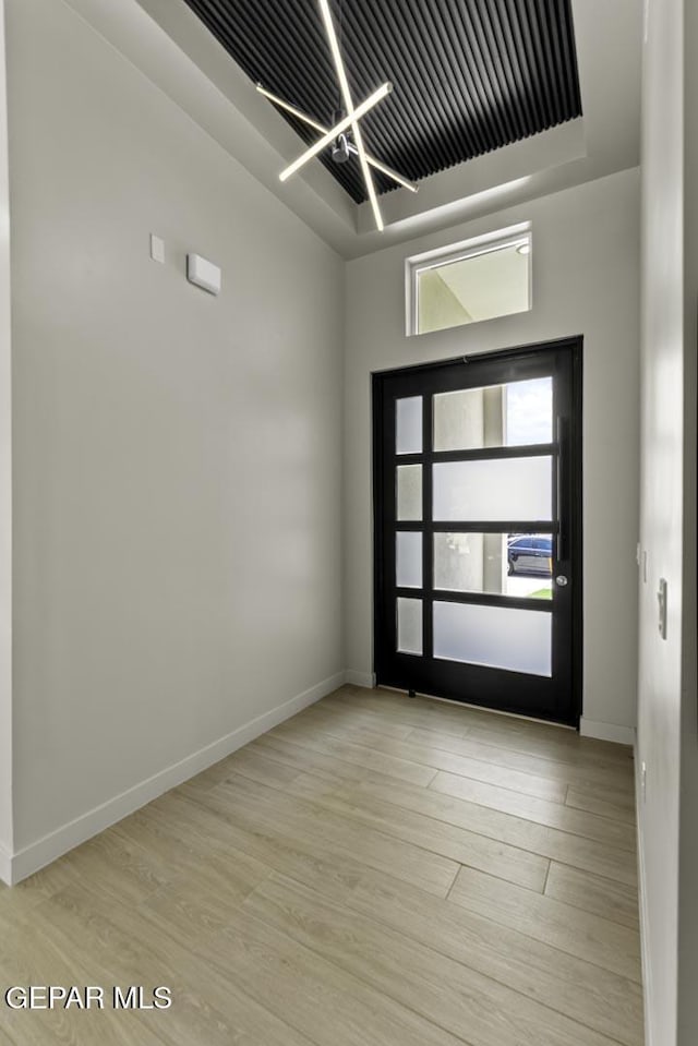 12869 Kingsbury Ave, Horizon City, TX 79928 - spare room featuring a chandelier and wood finished floors