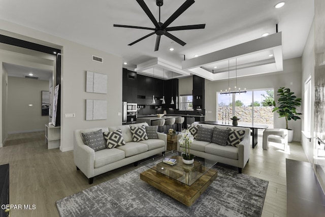 12869 Kingsbury Ave, Horizon City, TX 79928 - living area featuring ceiling fan, a chandelier, light wood-type flooring, and recessed lighting