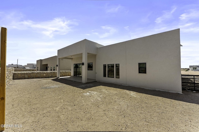 12869 Kingsbury Ave, Horizon City, TX 79928 - back of property featuring stucco siding and a patio