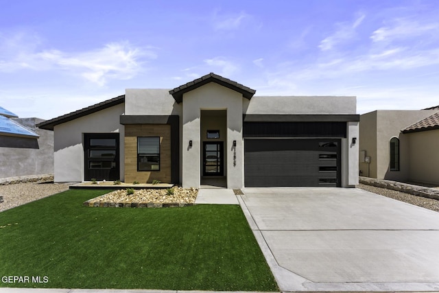 12869 Kingsbury Ave, Horizon City, TX 79928 - contemporary house with an attached garage, driveway, stucco siding, and a front yard