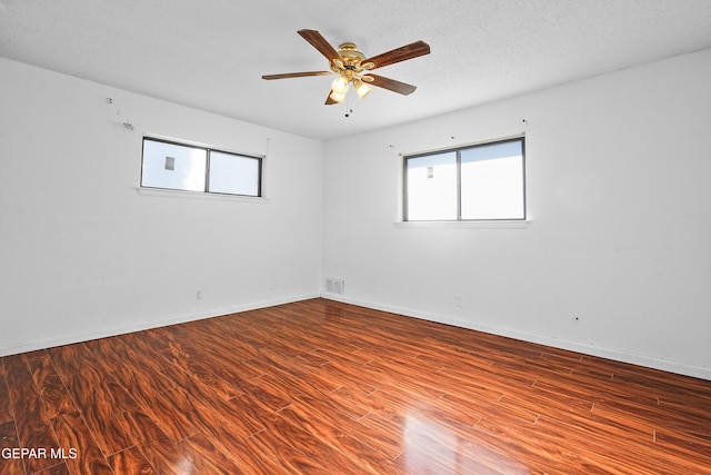 unfurnished room with hardwood / wood-style flooring, plenty of natural light, and ceiling fan