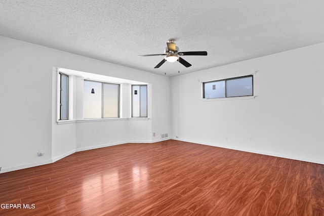 unfurnished room featuring a textured ceiling, ceiling fan, and wood-type flooring