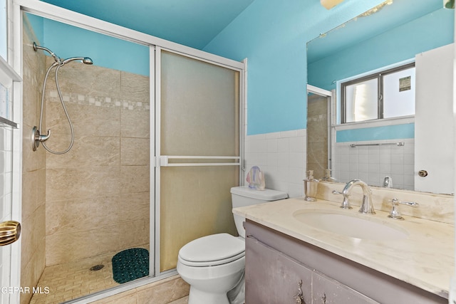 bathroom featuring toilet, walk in shower, and vanity