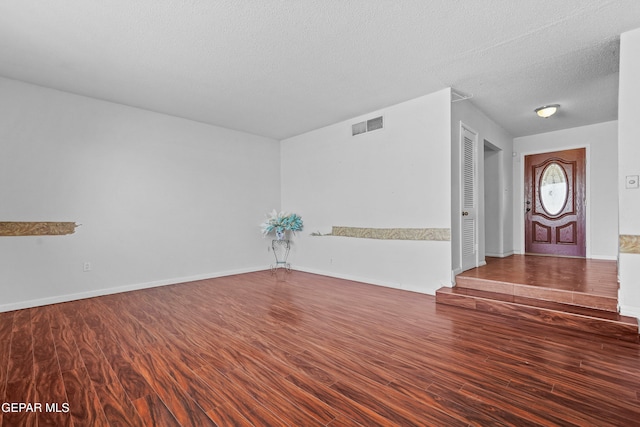 entryway featuring wood-type flooring and a textured ceiling