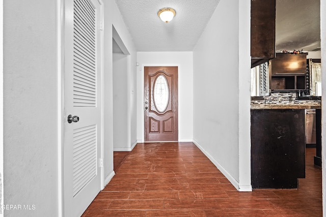 entrance foyer featuring wood-type flooring and a textured ceiling