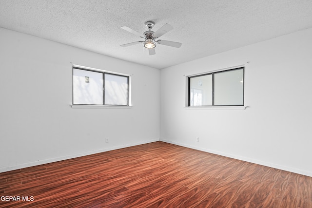 unfurnished room with ceiling fan, a textured ceiling, and dark hardwood / wood-style floors