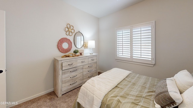 bedroom featuring baseboards and light colored carpet