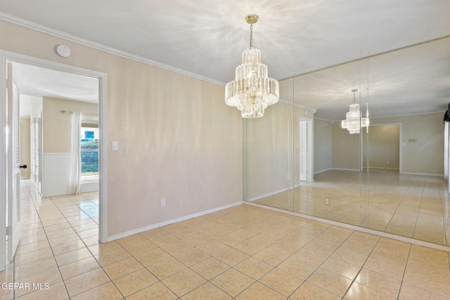 empty room with light tile patterned floors, crown molding, and an inviting chandelier