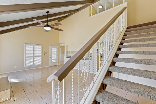 staircase featuring vaulted ceiling, ceiling fan, and tile patterned flooring