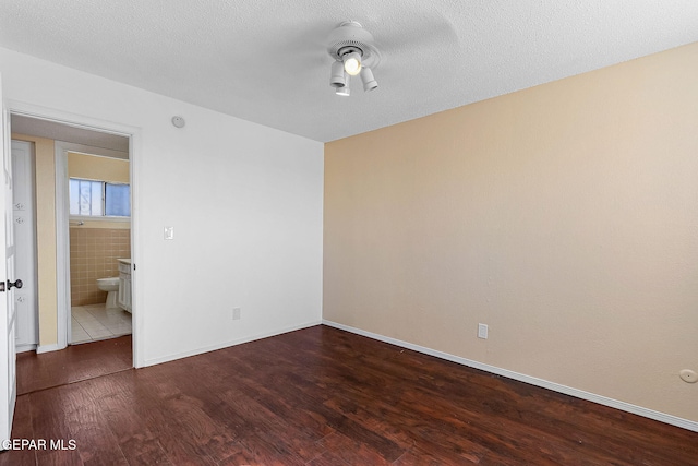 unfurnished bedroom featuring a textured ceiling, ceiling fan, and wood-type flooring