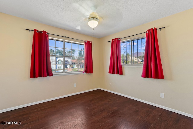 empty room featuring ceiling fan, a textured ceiling, and hardwood / wood-style floors