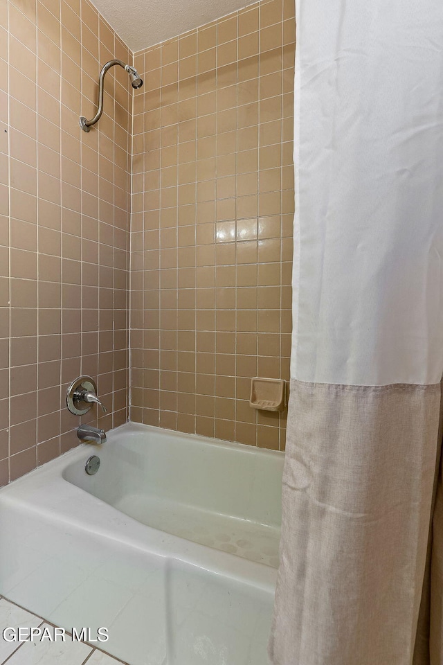 bathroom with shower / tub combo and tile patterned floors