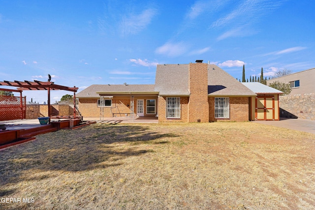 back of house with a lawn, a pergola, and a patio