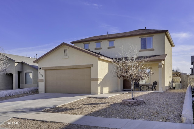 view of front property featuring central AC and a garage