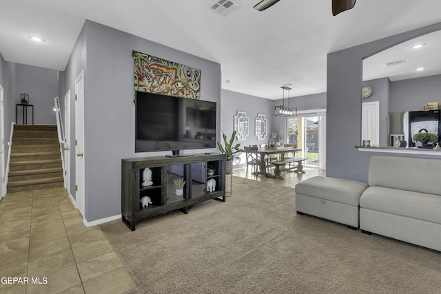 living room with ceiling fan and tile patterned flooring