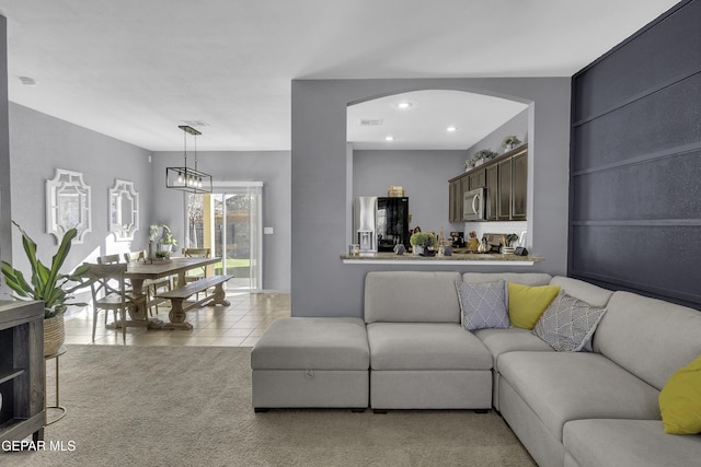 tiled living room with an inviting chandelier